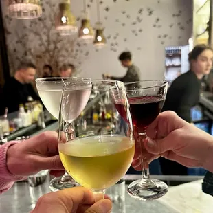 people clinking wine glasses