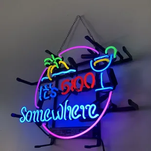 a neon sign hanging on a wall