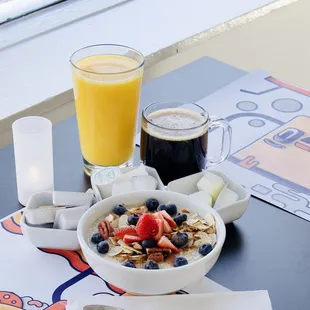 a bowl of oatmeal and a glass of orange juice