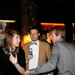 two men and a woman at a party