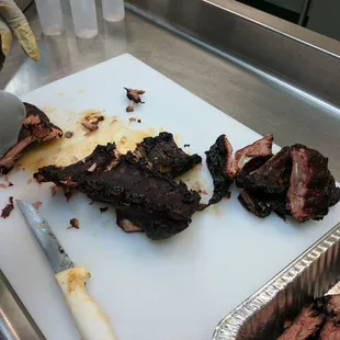 Dada cutting smoked meat