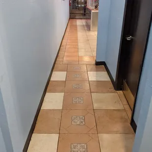 a long hallway with tiled floors