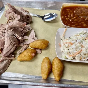 Pulled pork with baked beans, cole slaw &amp; hush puppies.