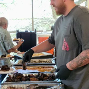 Frank serving his delicious bbq to the event attendees.