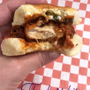 a hand holding a sandwich