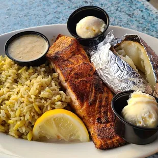 Grilled salmon was tender, wonderful flavor served with 2 sides of rice pilaf and baked potato.