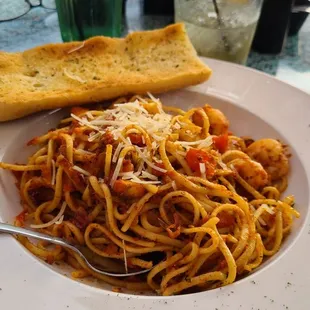 Seafood Diavola is shrimp and scallops sauteed  and tossed with marinated tomatoes, garlic, red onions and basil with linguine noodles.