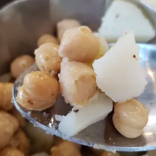 Step 2 of pani puri creation... scoop up some potato and chickpea filling