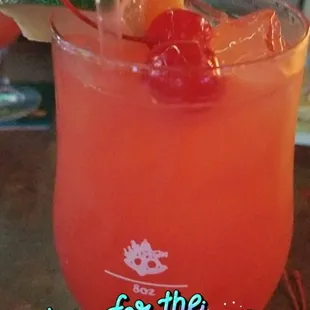 a drink in a glass with a straw and garnish garnish