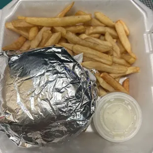 A wrapped burger and fries