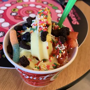 an ice cream sundae with fruit and sprinkles