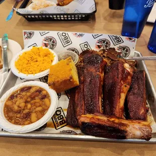 St Louis Ribs entree w/rice, baked beans &amp; cornbread in foreground.  Staten Island Bomber sandwich in background w/macaroni salad.