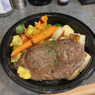 Ribeye with lemon truffle butter and potatoes and mixed roasted seasonal vegetables