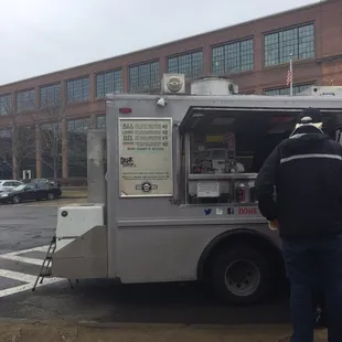 a man standing in front of a food truck