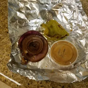 Big 'o thick slice of red onion and a green pepper cut in half. Why? Whyyy!?