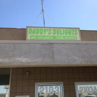 Sign is difficult to see from the street, but this photo should help you find it...