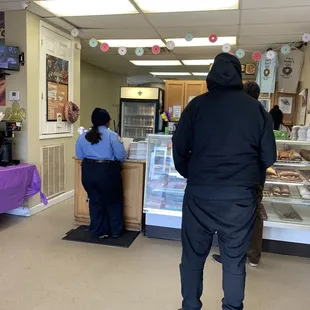 a man and a woman in a bakery
