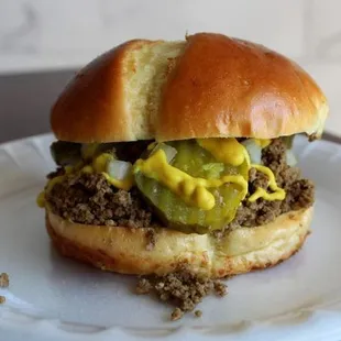 a hamburger on a paper plate