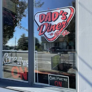 the reflection of the sign in the window