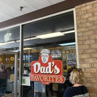 a woman looking in a store window