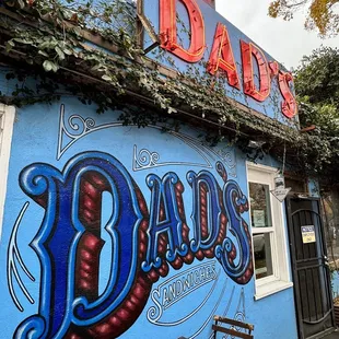 a blue building with a sign on it