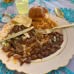Birria, rice, beans, roll.