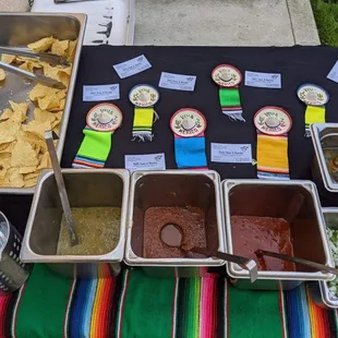 Chips and three salsas...mild, medium and hot from left to right. Also freshly chopped onion and cilantro mix and pickled jalapenos.