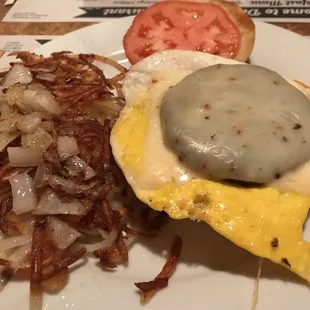 Dady Oh&apos;s  Hard roll, fried egg, sausage patty, pepper Jack cheese and tomato. Hash browns with sautéed onions.