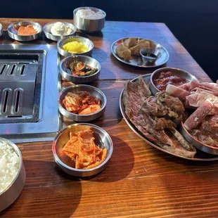 All the sides with tray of meat