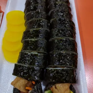 a plate of sushi rolls