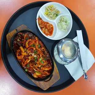 ojingeo bokkeum- Spicy squid stir fry.  Banchan- Kimchi, sesame mung bean, and creamy Potato salad