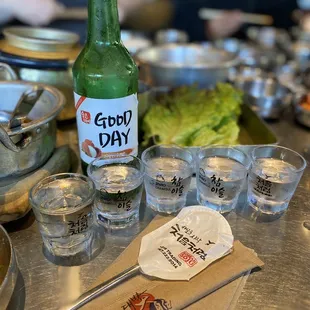 a bottle of beer and shot glasses