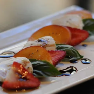 a plate of food with strawberries and mozzarella