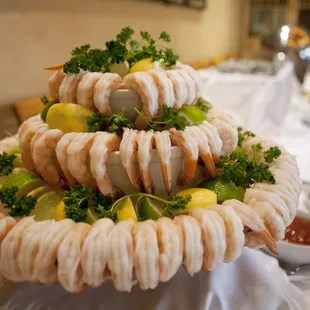 a platter of shrimp and lemons