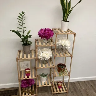 a shelf with flowers and candles