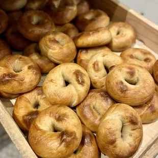 a wooden box full of bagels