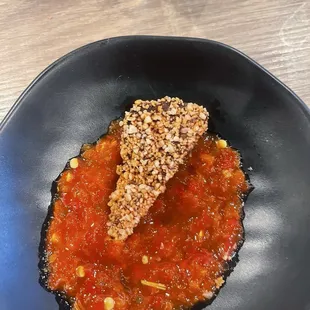 Pork appetizer, dipped in heirloom house chile sauce