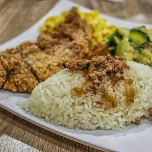 a plate of rice, meat, and vegetables