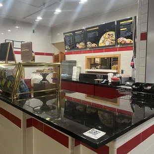 a restaurant with a counter and counter tops