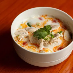 a bowl of soup on a wooden table