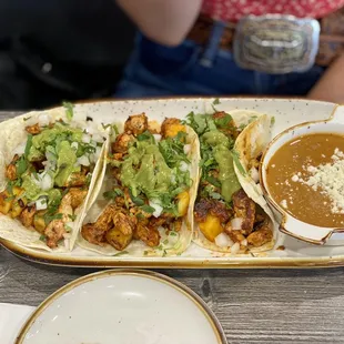 a plate of tacos and a bowl of soup