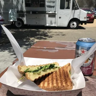 a sandwich and a can of soda