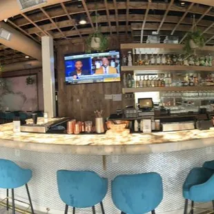 a bar with blue chairs