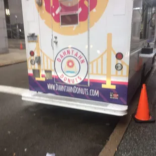a donut truck parked on the side of the road