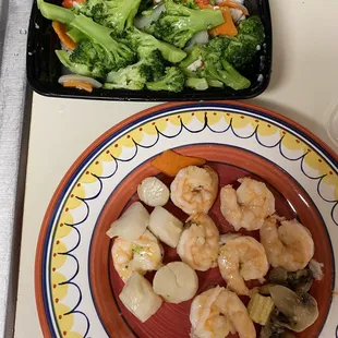 shrimp, broccoli, and carrots on a plate