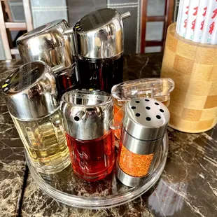 6 condiments &amp; chopsticks on tables