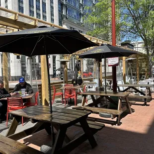 a man sitting at a table with an umbrella