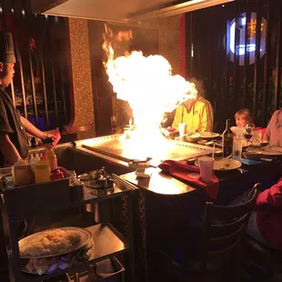 Hibachi chef makes a big fire.