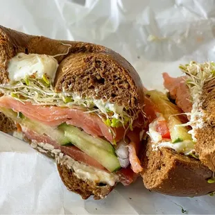 a bagel sandwich with meat and vegetables