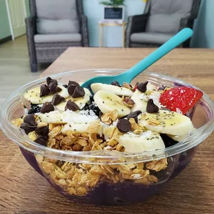 Acai smoothie bowl with bananas, strawberries, blackberries, and blueberries.